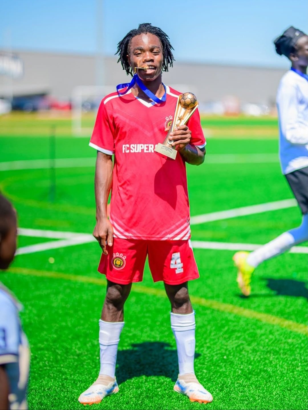 FC Super Sport player number 4 holding the championship trophy