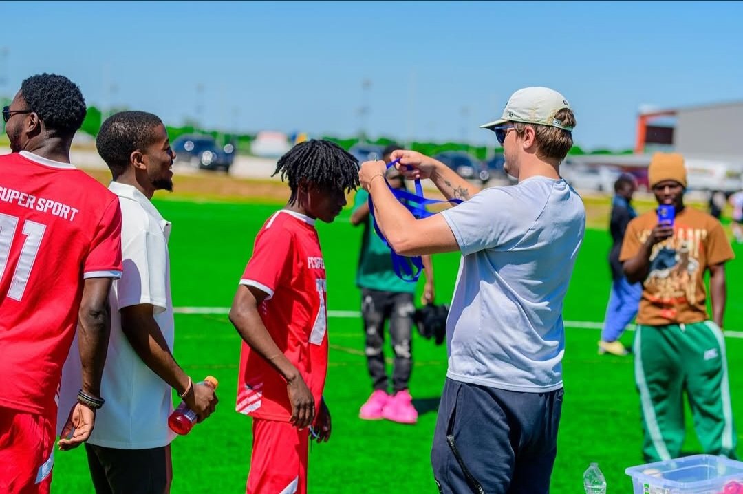 FC Super Sport player receiving his winner's medal after the final