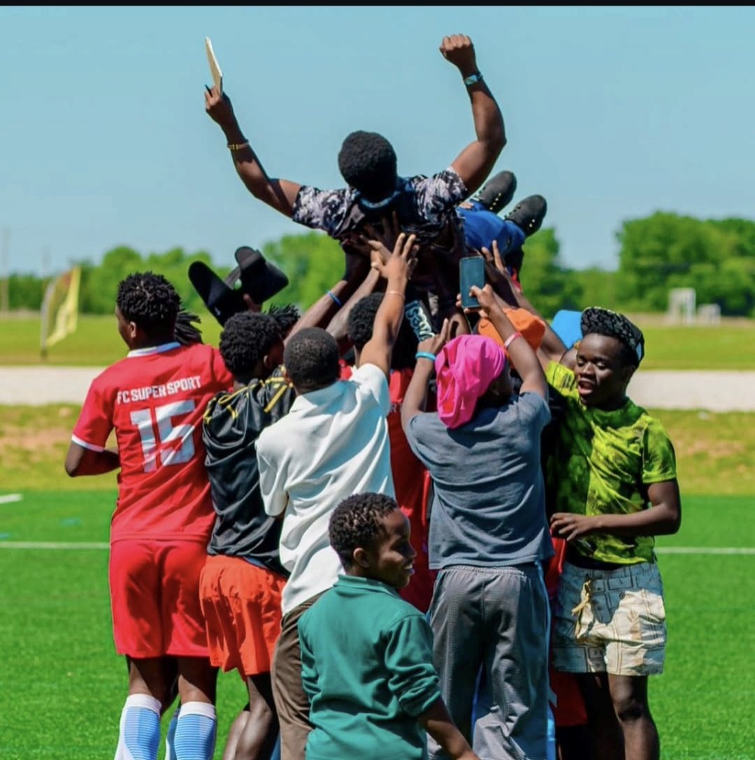 FC Super Sport players lifting a teammate in the air during the championship celebration