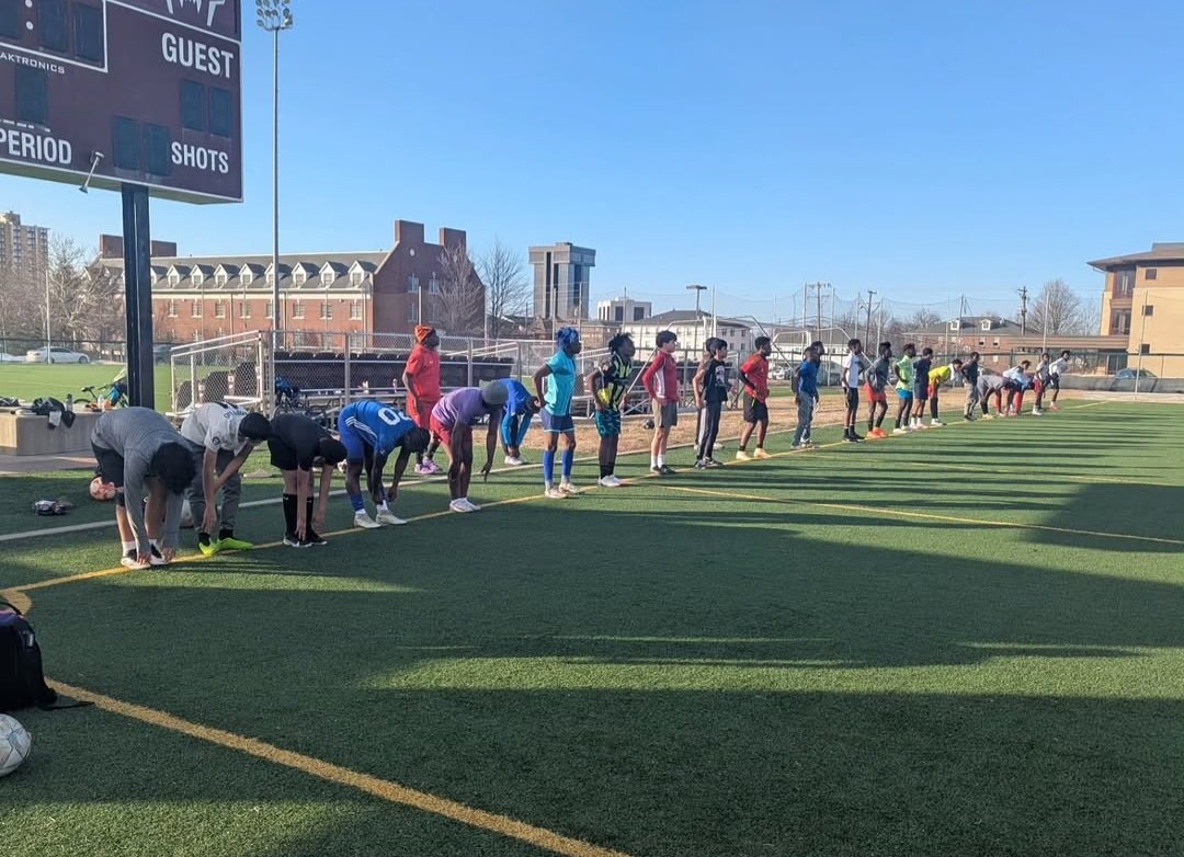 FC Super Sport players lined up for stretching exercises on the field