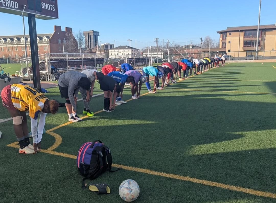 FC Super Sport players doing warm-up stretches on the pitch